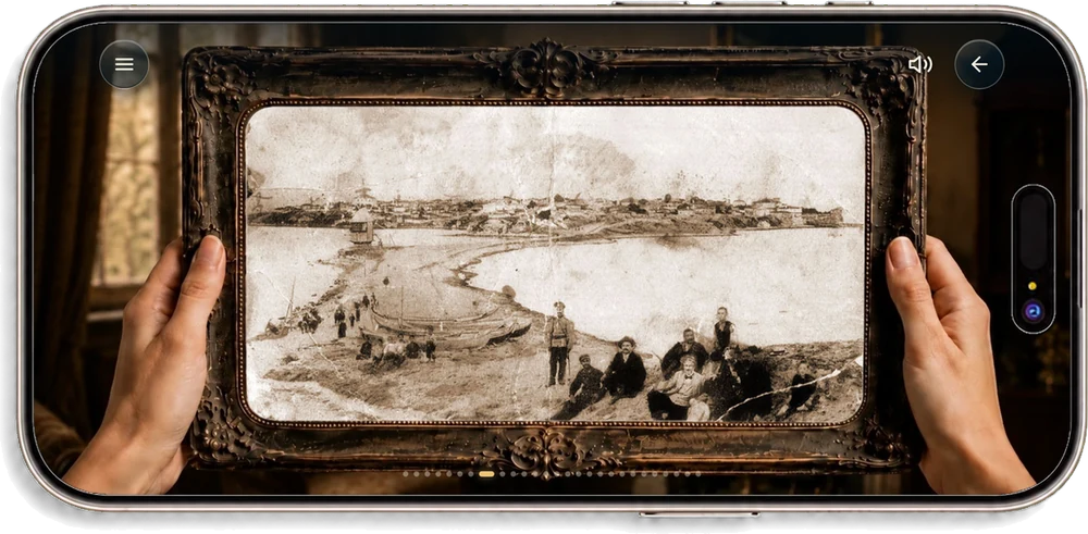 The phone held sideways, showing an antique frame held in two hands